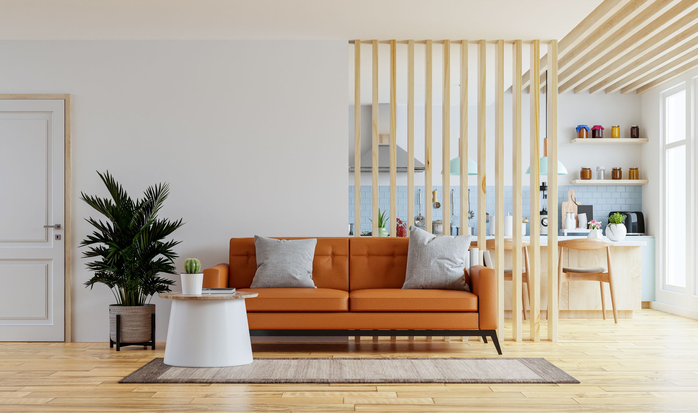 Paneles de madera alistonada para separar ambientes entre salón y cocina en una casa moderna