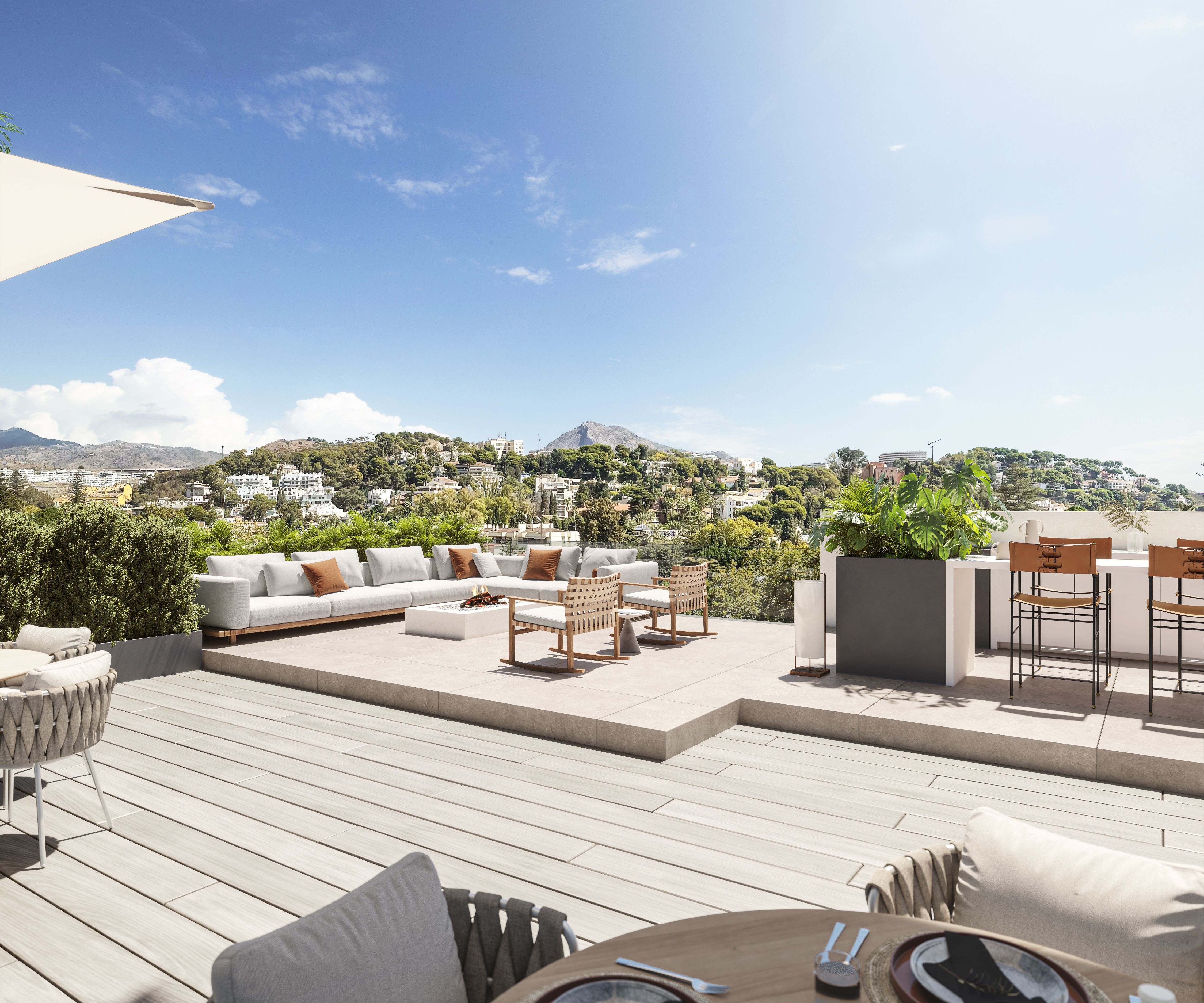 Rooftop panorámico de Be Grand El Limonar con zona lounge y vistas a las colinas de Málaga
